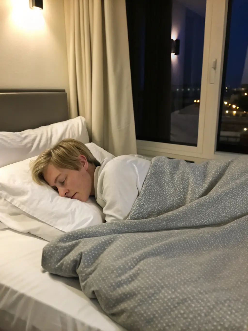 A woman peacefully sleeping with a SERENA meditation playing on her phone, highlighting the sleep-enhancing benefits of the subscription.